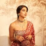 Pooja posing in palace courtyard with marigold garlands and oil lamps