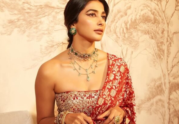 Pooja posing in palace courtyard with marigold garlands and oil lamps