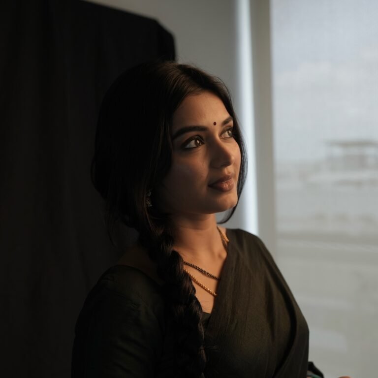 Full-length shot of Priyanka posing with backlight in sheer black saree