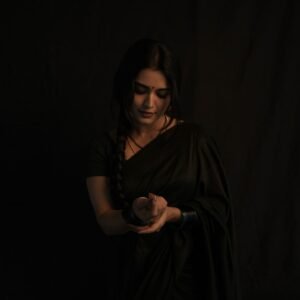 Full-length shot of Priyanka posing with backlight in sheer black saree