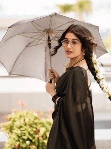 Full-length shot of Priyanka posing with backlight in sheer black saree