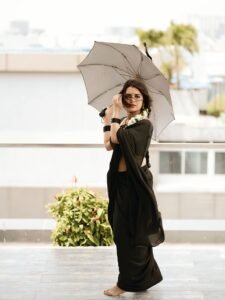 Full-length shot of Priyanka posing with backlight in sheer black saree
