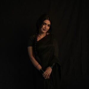Full-length shot of Priyanka posing with backlight in sheer black saree