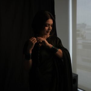 Full-length shot of Priyanka posing with backlight in sheer black saree