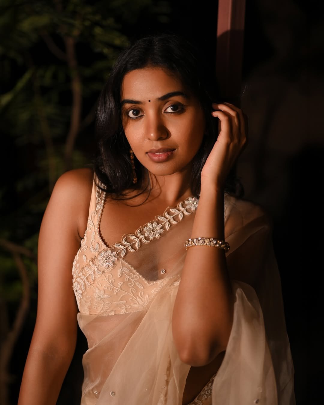 Shivathmika with diamond studs and dewy makeup in sheer attire