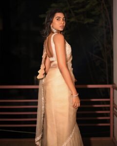 Shivathmika with diamond studs and dewy makeup in sheer attire