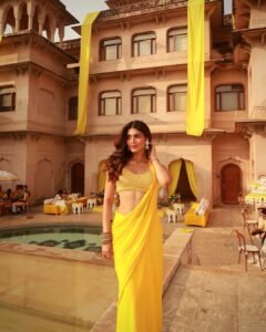 Close-up of Trisha wearing gold vanki and jasmine-adorned bun