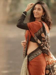 Close-up of Trupti wearing ruby jhumkas and bold red lip in ethnic attire