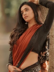 Close-up of Trupti wearing ruby jhumkas and bold red lip in ethnic attire
