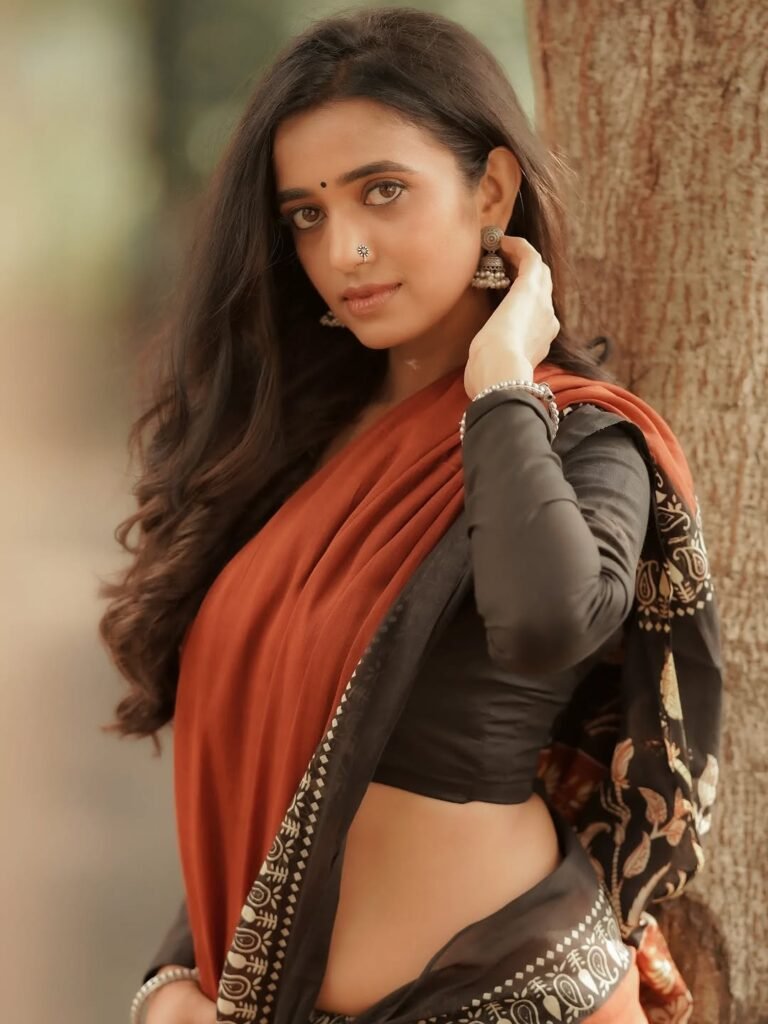 Close-up of Trupti wearing ruby jhumkas and bold red lip in ethnic attire