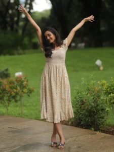 Trupti Ravindra in ivory floral wrap dress in countryside garden