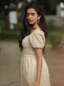 Trupti Ravindra in ivory floral wrap dress in countryside garden