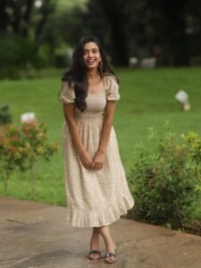 Trupti Ravindra in ivory floral wrap dress in countryside garden