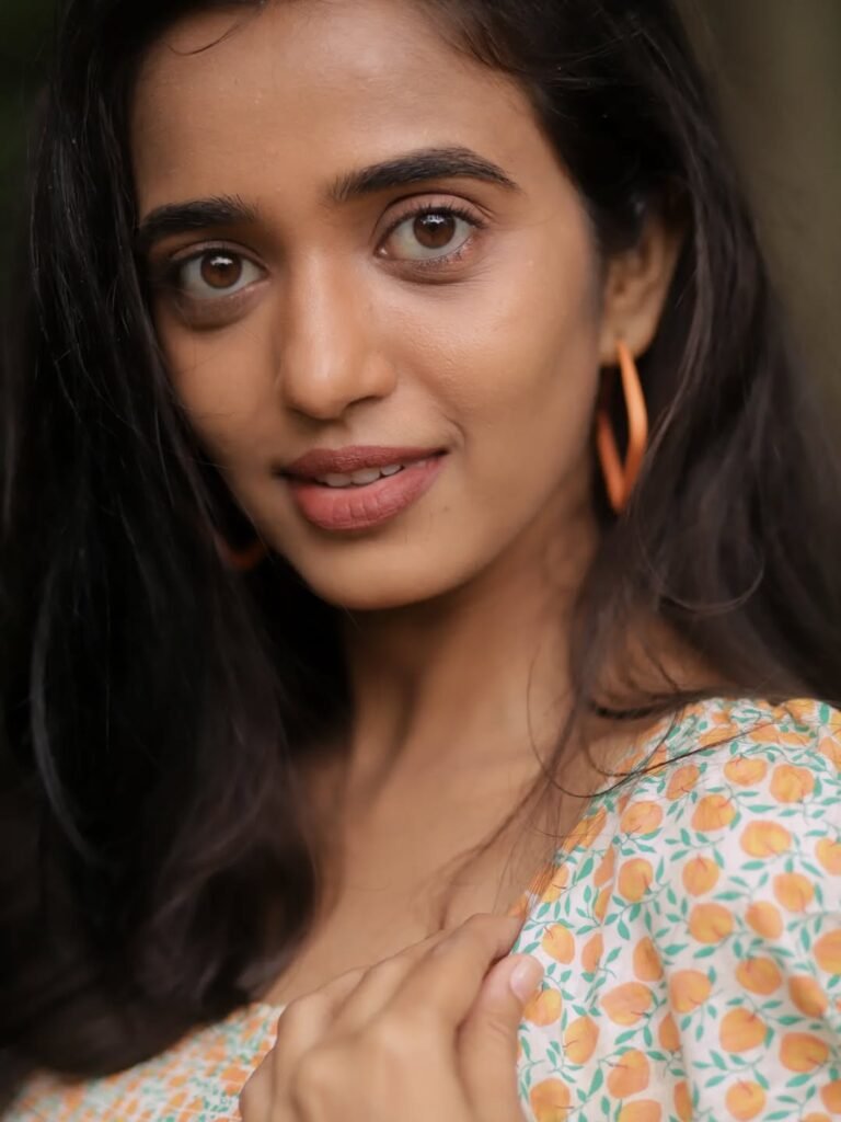 Trupti Ravindra in ivory floral wrap dress in countryside garden