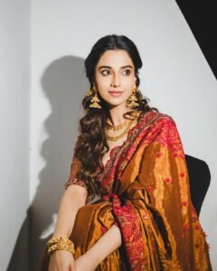 Meenakshi Chaudhary Stunning Red Saree Photos 2026 trending celebrity photos